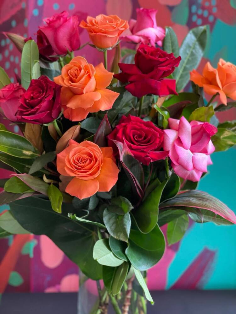 One Dozen Coloured Roses in Clear Glass Vase